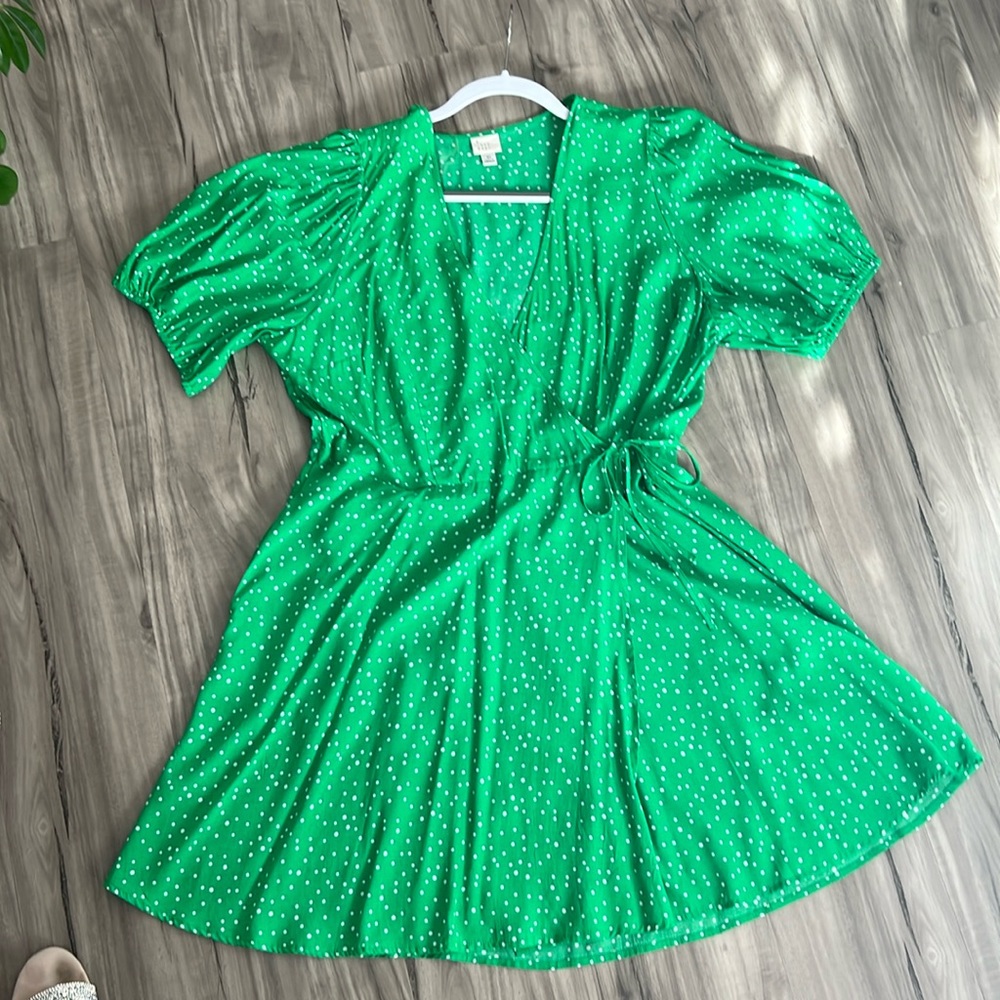 A New Day green dot faux wrap dress. It has pockets.